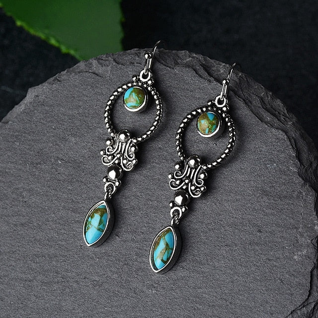 Vintage pair of earrings are pure 925 sterling silver. Embedded Turquoise Gemstone gives it an alluring look.